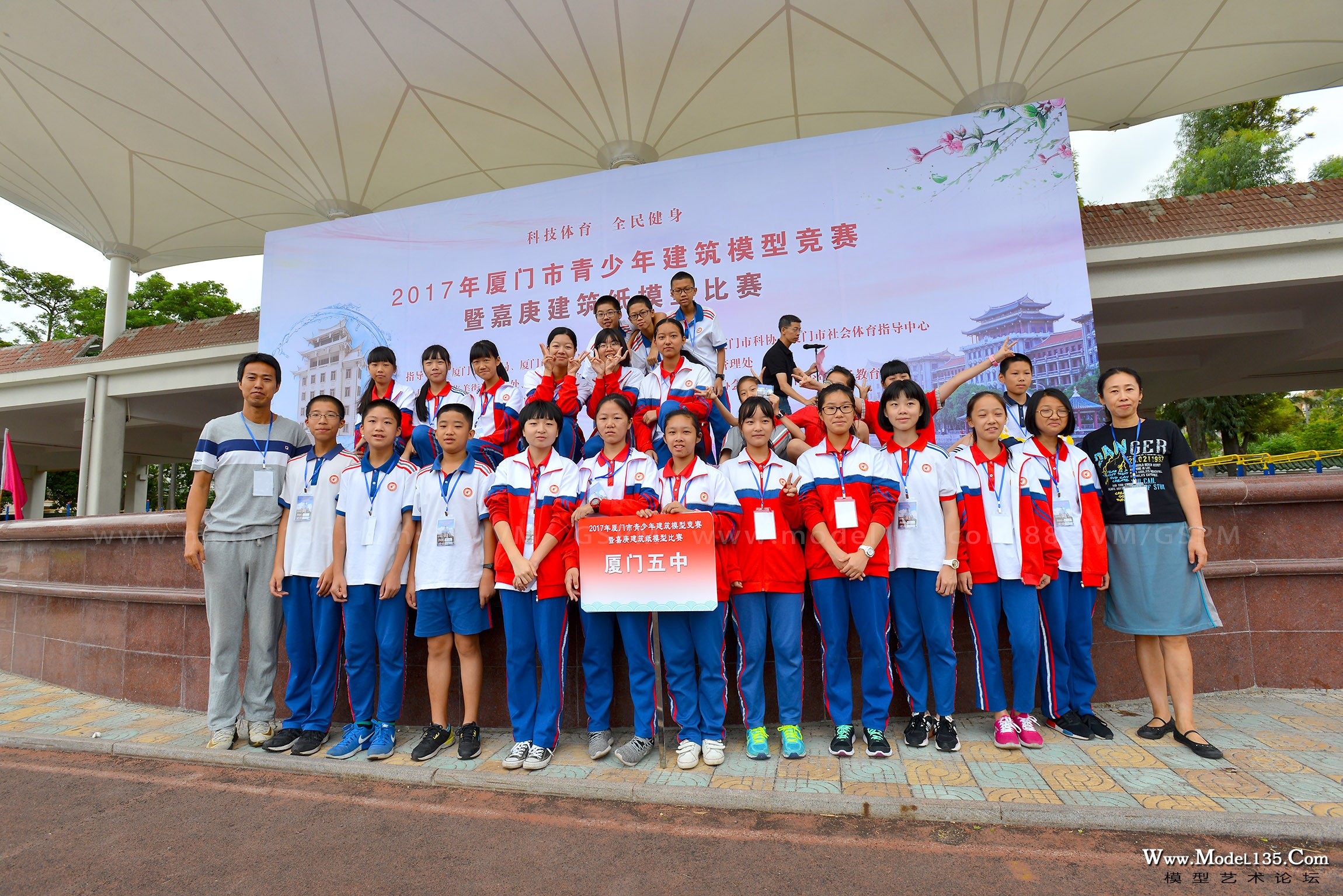 领取完器材的同学们纷纷在大会主背景板前合影留念